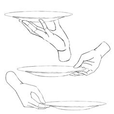 two hands holding plates with one hand reaching for the other