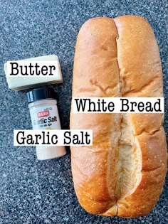 a loaf of white bread next to garlic salt