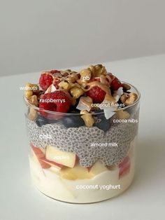 a glass container filled with fruit and nuts