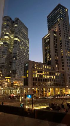 some very tall buildings in the city at night