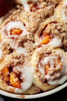 an apple cinnamon roll with icing on a plate