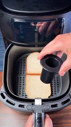 someone is using a toaster to make bread
