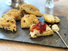 scones with jam and butter on a slate board