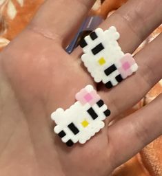 someone is holding their hand with two small pixeles on it
