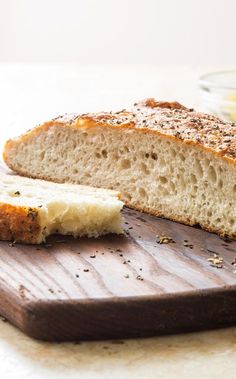 a loaf of bread sitting on top of a wooden cutting board