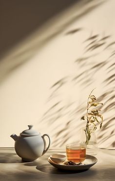 a tea pot and cup on a table