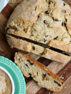 a loaf of bread sitting on top of a wooden cutting board