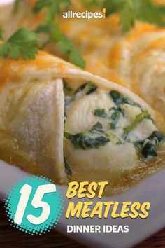 a white plate topped with food covered in cheese and spinach