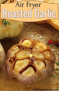 an air fryer roasted garlic on a wooden cutting board with other ingredients in the background