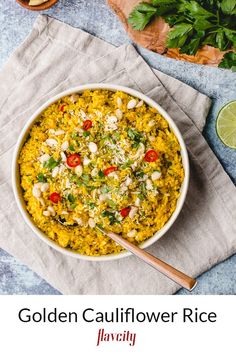 a white bowl filled with yellow rice and garnished with cilantro
