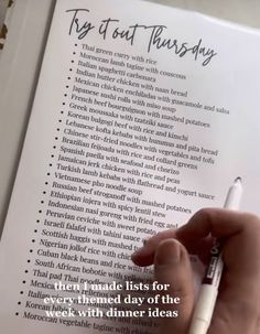 someone is writing on an open book with a pen in their left hand and the words key to out thursday written above it