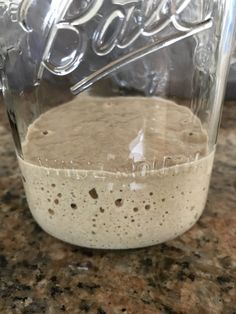 a glass jar filled with liquid sitting on top of a counter