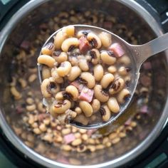 a spoon full of beans and ham in an instant pot