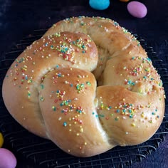 a close up of a doughnut with sprinkles on a cooling rack
