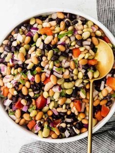 a white bowl filled with beans and vegetables