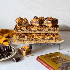 a stack of granola bars sitting on top of a table next to a book
