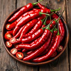 red hot peppers in a bowl on a wooden table