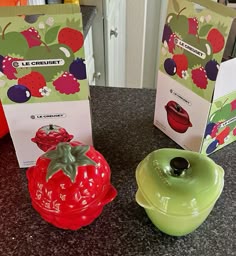 two small ceramic dishes sitting on top of a counter next to boxes with magnets