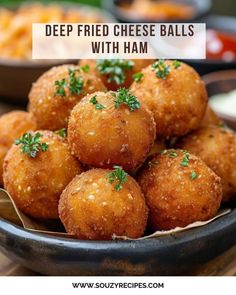 deep fried cheese balls with ham in a black bowl on a wooden table and text overlay reads deep fried cheese balls with ham