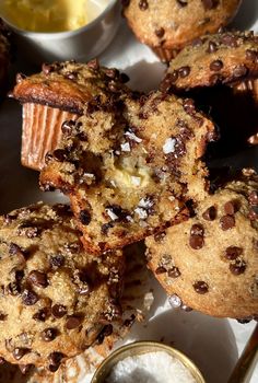 several chocolate chip muffins on a plate with dipping sauce