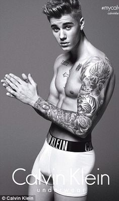 a man with tattoos on his arms and chest