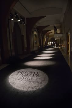 an empty hallway is lit up with light from the sun shining on it and there are no people