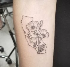 a black and white photo of a flower in the shape of indiana on a woman's arm