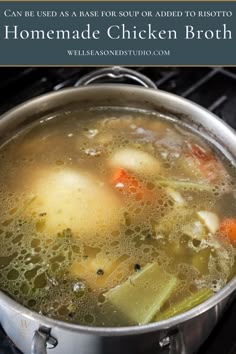 a pot filled with chicken broth sitting on top of an open stove burner