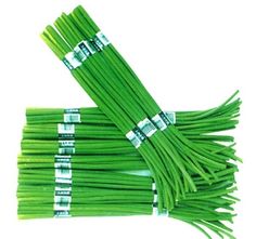 several bundles of green beans on a white background