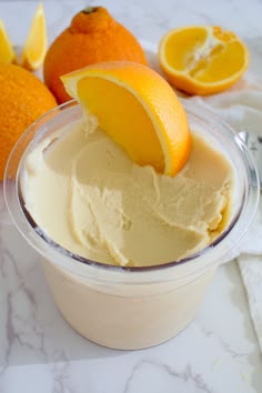 an ice cream sundae with oranges on the side