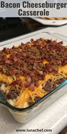 A cheesy bacon cheeseburger casserole in a baking dish, topped with golden melted cheese and bacon bits.