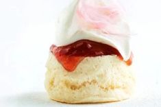 a pastry with icing and strawberry jam on top