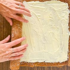 two hands that are on top of a piece of bread