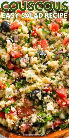 a close up of a bowl of couscous salad with tomatoes, black olives and feta cheese