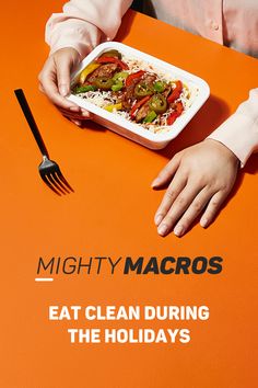 a person sitting at a table with a plate of food and fork in front of them