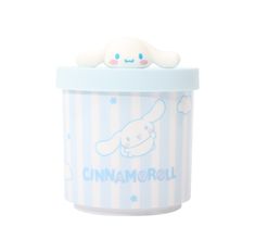 a cup that has some kind of animal on it's top and is blue with white stripes