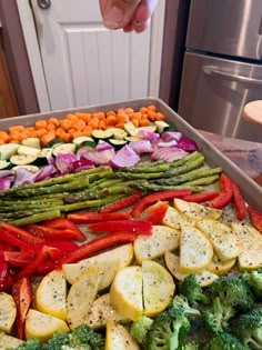 a pan filled with vegetables and seasonings on top of a counter next to an oven