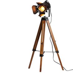 a wooden tripod lamp with a light on it's legs and a white background