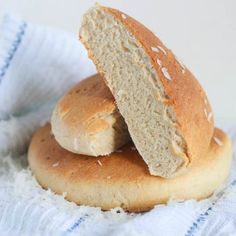 two loaves of bread sitting on top of each other next to a white towel