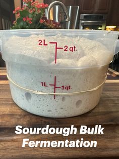 a large bowl filled with lots of bubbles on top of a wooden table