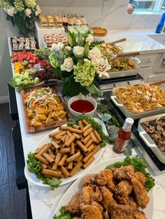 a buffet table filled with different types of food and condiments on plates next to each other
