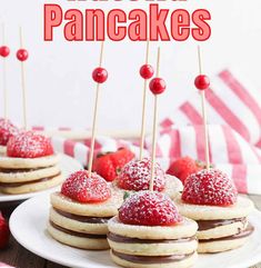 strawberry pancakes on a plate with strawberries in the background and text overlay that reads, strawberry pancakes