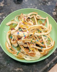 a green plate topped with lots of food