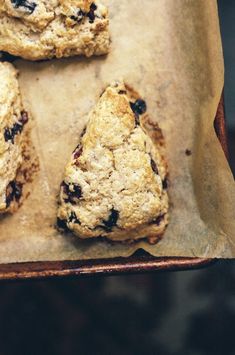 three scones sitting on top of a piece of parchment paper