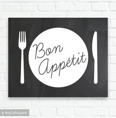 a sign that says bon appetit with a fork and knife on it, against a white brick wall