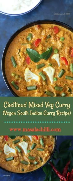 a bowl filled with curry and vegetables on top of a blue table
