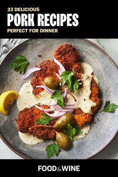 a plate with some food on top of it and a lemon wedge next to it