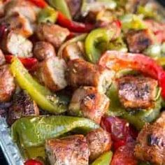 sausage and peppers are being cooked on the grill