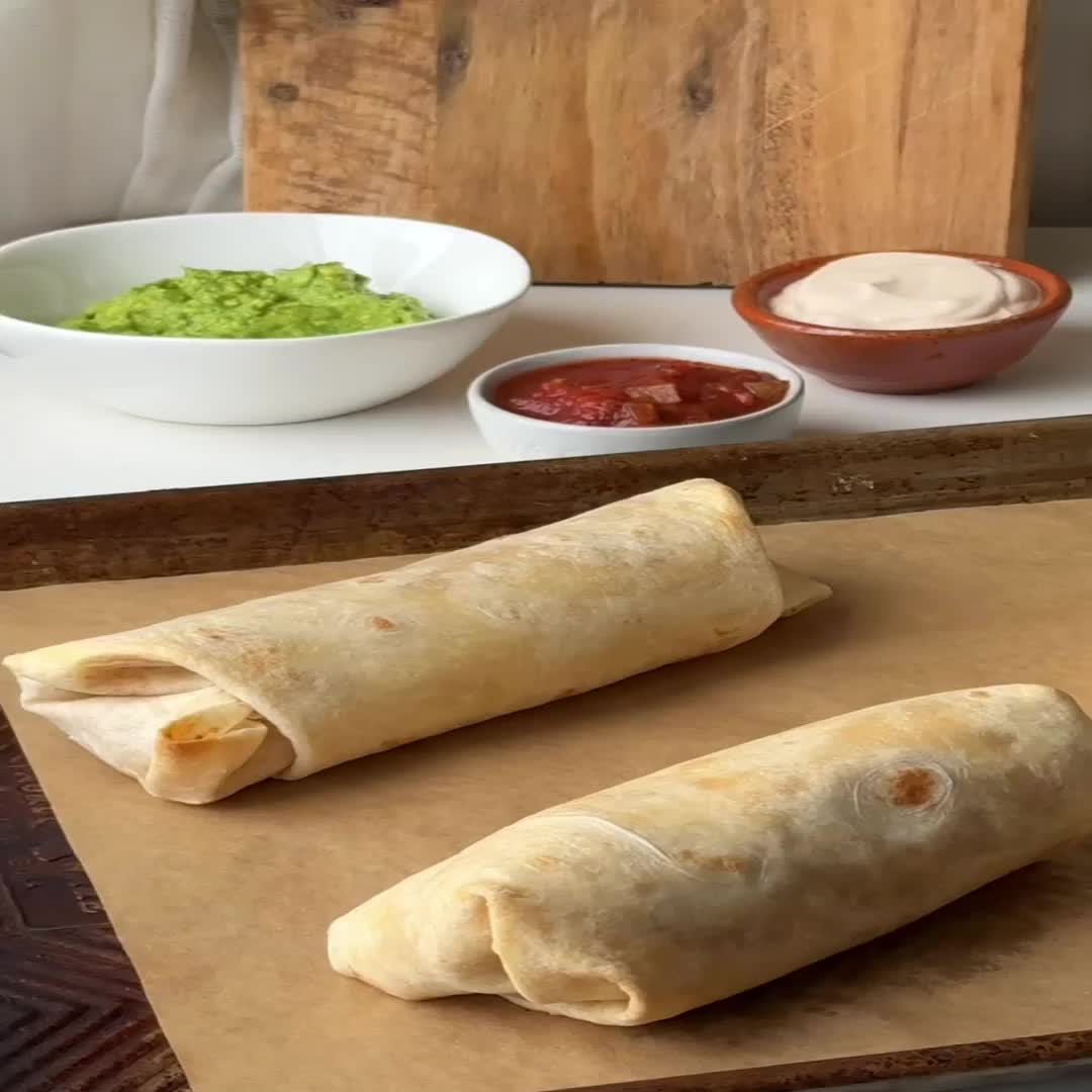 Classic bean and cheese burritos filled with flavorful and creamy refried beans, diced onions, and two types of shredded melty cheese!   Ready in less than 30 minutes, these burritos are great for making ahead, meal prep, and even freezing for later.