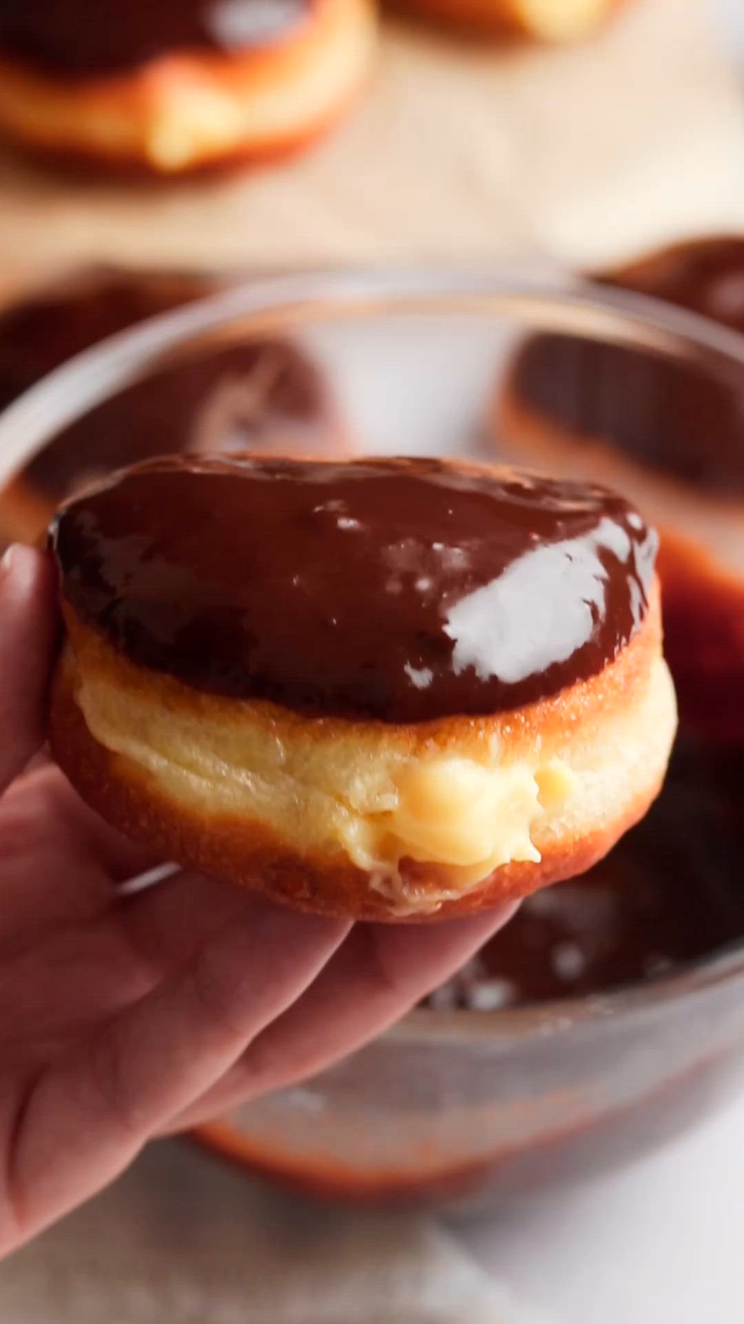 These Boston cream donuts are made with fluffy yeast dough, filled with creamy vanilla custard, and topped with chocolate ganache.